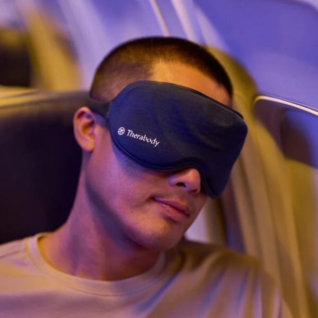 Man using smart sleep mask on a flight