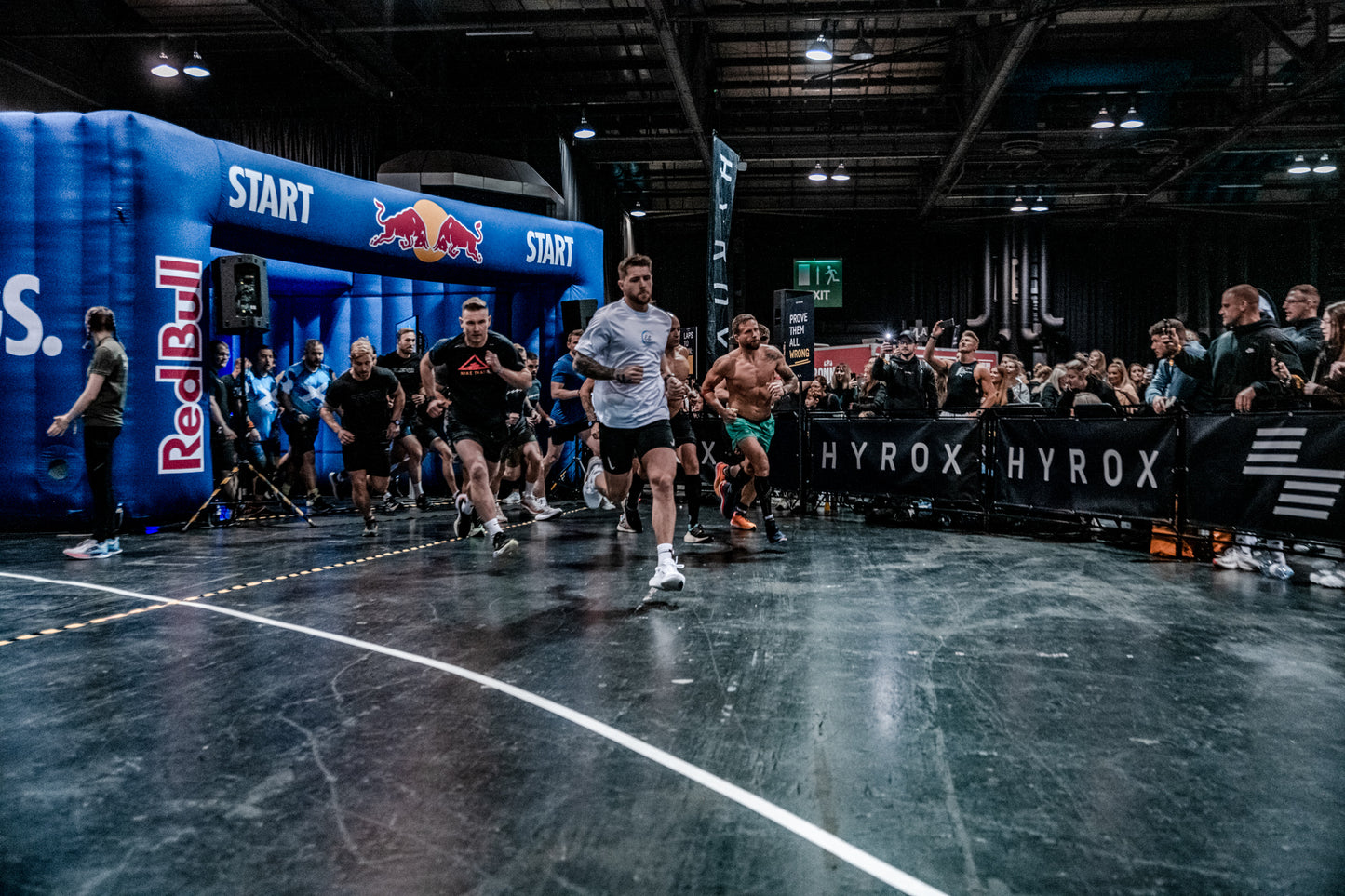 Athletes starting a race at a sports event with Red Bull and HYROX branding.